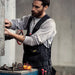 Man working on a piece of machinery with tools around him